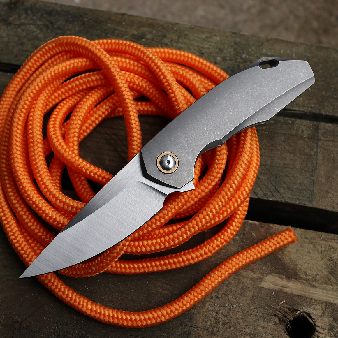 GiantMouse Knives GM6 Integral Titanium Folder with M390 Blade Steel and bronze pivot ring, view - fully open on orange rope